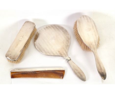GEORGE V FOUR PIECE LADY'S ENGINE TURNED SILVER DRESSING TABLE HAND MIRROR AND BRUSH SET, comprising; HAND MIRROR (a.f.), HAI