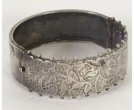 NINETEENTH CENTURY ENGRAVED SILVER HINGE OPENING BROAD BANGLE, unmarked, 1oz approx 