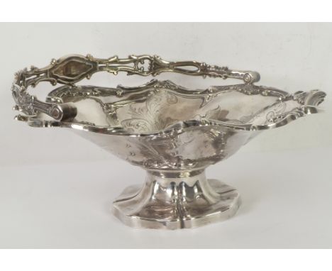 A WILLIAM IV SILVER CAKE BASKET, with cast and pierced scrolliated swing handle, the bowl foliate scroll engraved and chased 