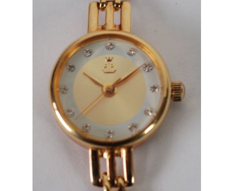LADY'S B+B QUARTZ WRIST WATCH, the circular dial with paste set batons, fancy gate pattern integral bracelet, the back of the