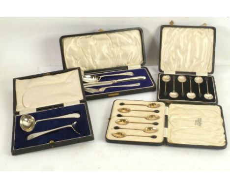 A CASED SET OF SIX EARLY TWENTIETH CENTURY SILVER COFFEE SPOONS, the bowls gilded and black and white enamelled on the unders