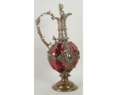 IMPRESSIVE W.M.F. SILVER PLATED AND CRANBERRY GLASS CLARET JUG, in the Renaissance style, the flattened orbicular liner house