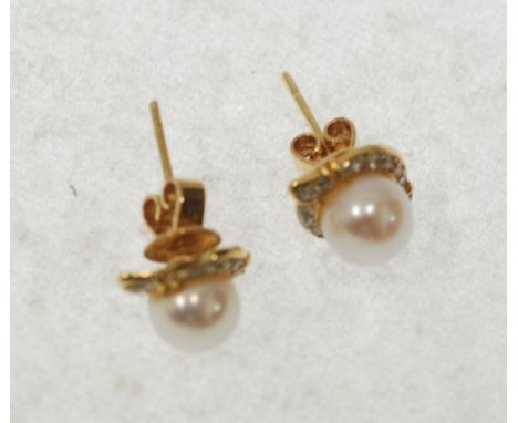 PAIR OF CULTURED PEARL AND DIAMOND SET STUD EARRINGS, pearls of 7.8mm diameter, with cross over surround set with 12 single c