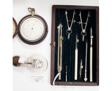 An atmospheric pressure gauge, a cased architects drawing set and an unusual light bulb (3) 