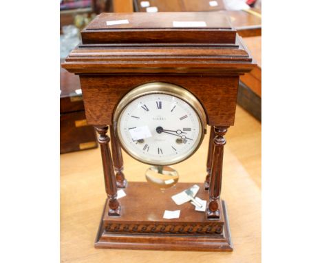 A reproduction of a Newton mantle clock issued by Forbes of Liverpool, pendulum and keys 