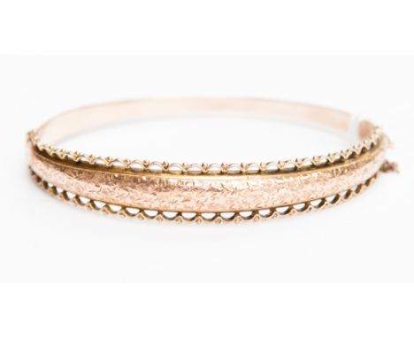 A rose gold bangle, stamped 375, weighing approx 8.6 grams, in original box from Glasgow 