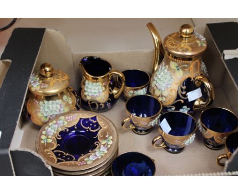 An enamelled blue glass part coffee set, including coffee pot, cream, sugar and cover, six cups and saucers 