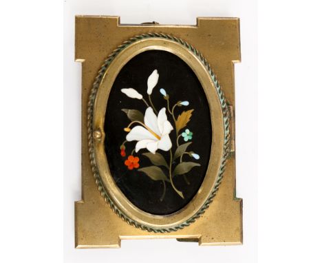 A Victorian gilt metal easel photograph frame, c.1880, inset oval pietra dura plaque decorated with a white flower, height 12