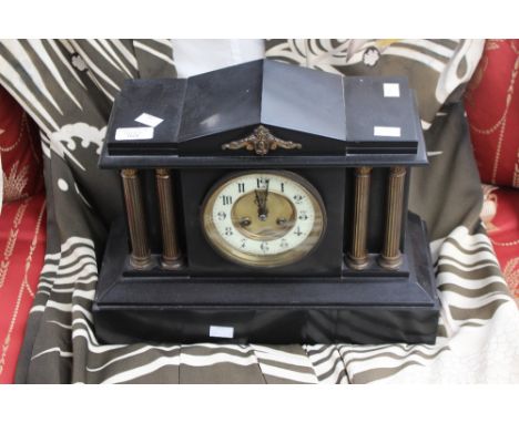 Slate mantle clock, circular dial with Arabic numerals, two decorative columns either side.
