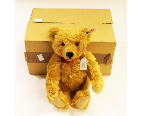 A boxed limited edition Steiff Christie's 'James' golden brown 28 cm teddy bear, silver ear button and pendant, no 772 of 176