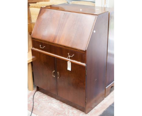 Two 20th century mahogany bureaux, one in the George III style, the fall enclosing a fitted interior and raised on a base wit
