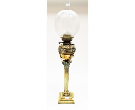 A Victorian brass oil lamp, with frosted etched shade and decorated reservoir 