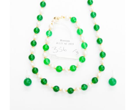 A Freshwater Pearl and Jade alternating single strand necklace, with 6mm pearls and 7mm jade beads, each set between gilt met