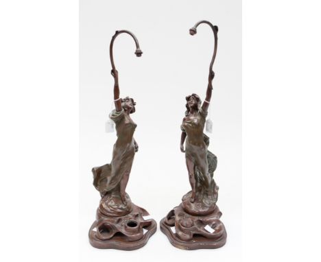 A pair of Art Nouveau spelter table lamps, probably French, cast in the form of classical ladies after Rousseau, with their r