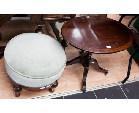 A small mahogany oval pedestal table and an early 20th Century upholstered stool. (2)
