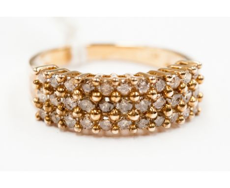 A three row diamond half hoop ring set with thirty three brilliant cut cognac diamonds measuring 2 mm diameter approx in claw