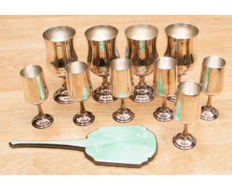 A set of six small and four large plated goblets and a plated hand mirror with green engine turned enamelled design to rear 