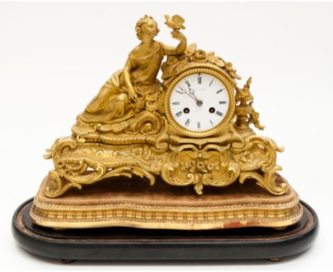 A French ormolu bracket clock under glass dome, late nineteenth century, the case as a reclining classical female with a dove