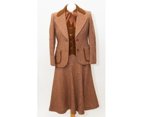 A ginger wool tweed four piece suit to include a swing skirt, velvet waistcoat, hacking jacket with velvet trim and tie-neck 