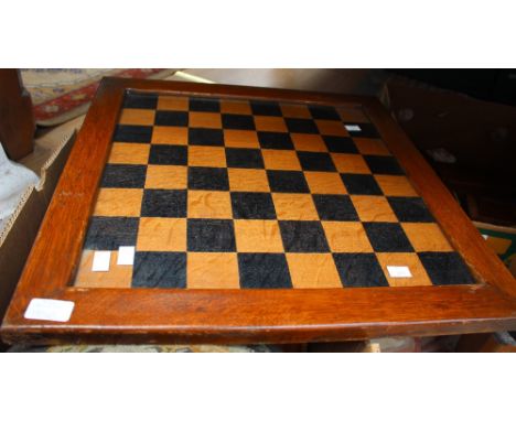 A folding wooden chess table with glazed top and a box containing a tapestry top footstool and wood and lacquer boxes (3) 