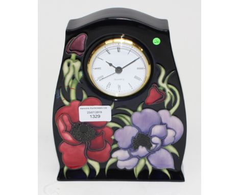 A Moorcroft 'Anemone Tribute' mantle clock, with tube lined decoration on a dark blue ground, 2nd quality, 21cm high