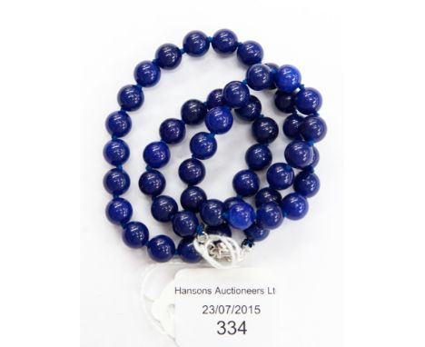 A Blue Jade single strand necklace, with approximately 48 round 7mm beads, each individually knotted and fitted with a white 