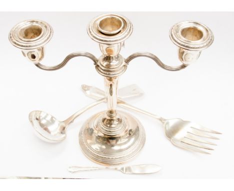 A silver two branch candle holder, with a silver butter knife, EPNS ladle and fish fork (4) 