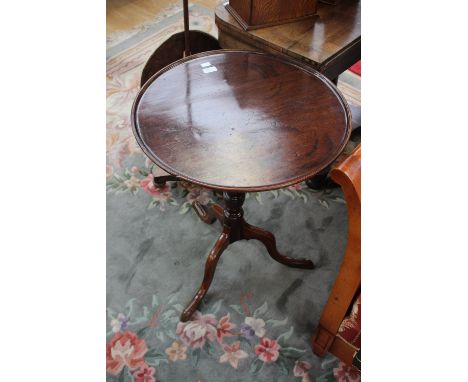 An early 19th Century mahogany tilt top tripod wine table with a dished top, 75 cm high approx 