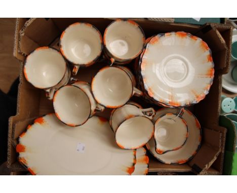 An Art Deco Green & Co Ltd hand painted tea set, decorated in orange and black edges, comprising twelve cups, twelve saucers,