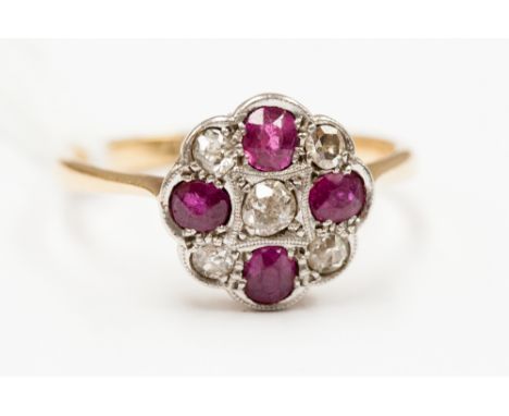 A ruby and diamond cluster ring, millegrain set old cut diamond to the centre and four rubies, the cardinal points interspers