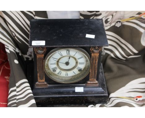 A late 19th Century American black lacquered iron mantle clock with incised gilt decoration and applied ionic plasters, Anson