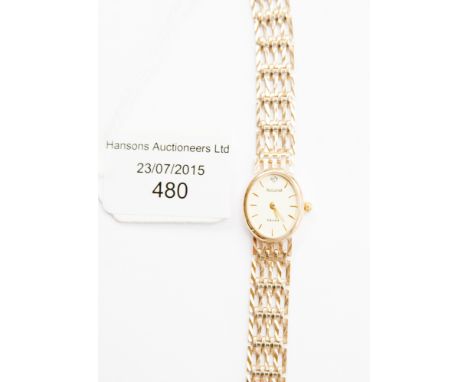 A ladies wristwatch, an oval champagne coloured dial with gilt hands and batons, set with an 8 cut diamond to twelve o clock,
