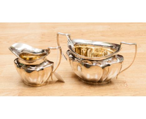 A George V silver milk jug and sucrier of heavy guage, lobed ogee form, gilded to the interiors, Sheffield 1917, 16.93 ozt ap