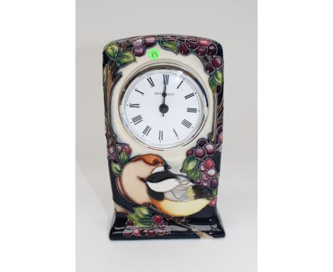 A Moorcroft 'Black Cap in Beauty' mantle clock, the clock with a white enamelled dial, the case with tube lined decoration on