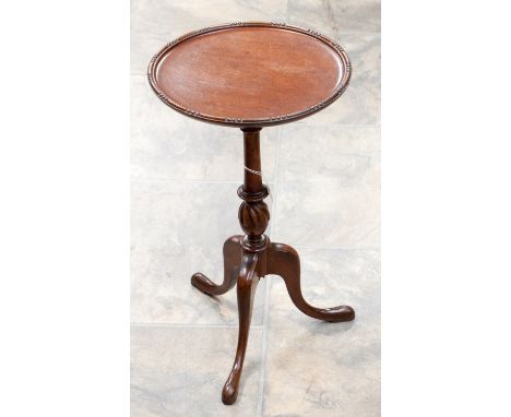 An early 20th Century mahogany tripod wine table, raised on three cabriole legs, 50 cm high 