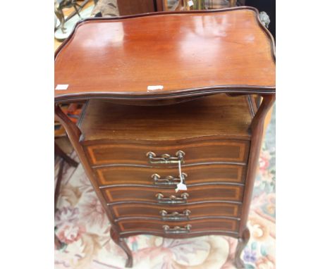 An Art Nouveau mahogany music cabinet, circa 1900, with boxwood and ebony stinging and satinwood crossbanding, the open shelf