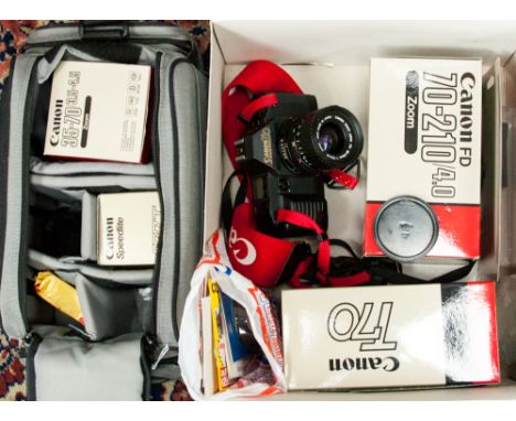 A Canon T70 camera, Canon 35-70 mm Macro zoom lens, Canon 277T flashgun, carrying case, etc 