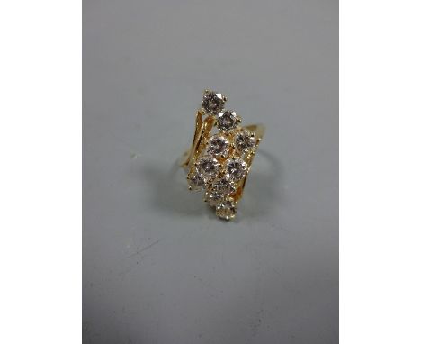 A DIAMOND RING, with spray of brilliant-cut diamonds to an asymetric shank, estimated total diamond weight 2.00ct, G-H colour