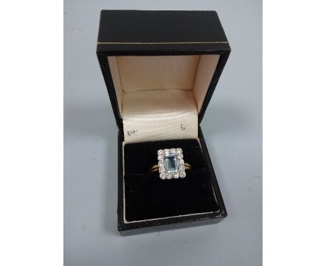 AN AQUAMARINE AND DIAMOND RING, with rectangular shape aquamarine within a surround of brilliant-cut diamonds, estimated tota