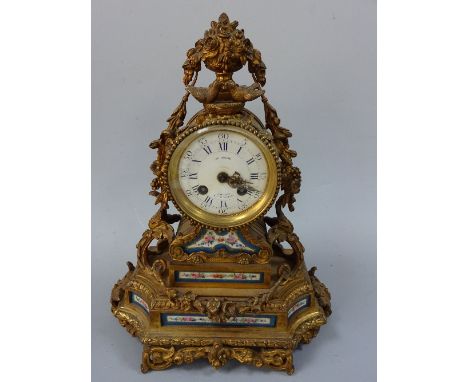 A VICTORIAN FRENCH MANTEL CLOCK, of balloon form having floral ceramic painted panels under on stepped gilt metal plinth base