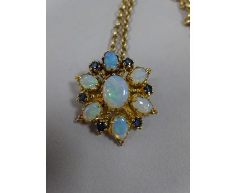 AN OPAL AND SAPPHIRE BROOCH PENDANT, with large central opal within a surround of further opal and sapphire accents, with a 9