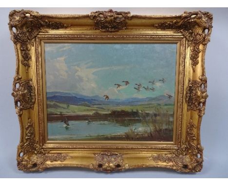 JOHN R. TOWNSEND (1930-2014), ducks in flight and landing on water amongst marshland, oil, inscribed Langdale Valley Westmoor