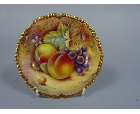 A ROYAL WORCESTER PLATE, having hand painted apple, peach and grapes to mossy bank, shaped gilt border, signed P English, bla