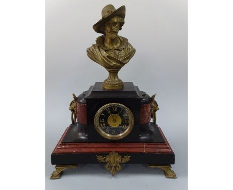 A BLACK SLATE AND RED MARBLE MANTEL CLOCK, with gilt figural mount, modelled as bearded cavalier in hat over drum movement, d