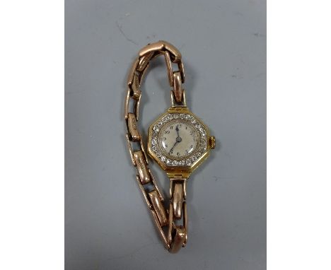 AN EARLY 20TH CENTURY DIAMOND WATCH, with circular shape dial within a surround of old-cut diamonds with hexagonal shape outl