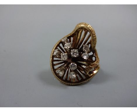 A DIAMOND RING, with spray of brilliant-cut diamonds within an abstract surround, to the plain tapered shank, estimated total