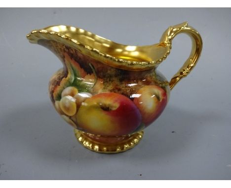 A ROYAL WORCESTER MILK JUG, having hand painted apples, white grapes and blackberries to mossy bank, with gilt loop handle an