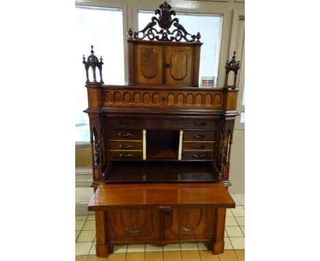 A CONTINENTAL HARDWOOD ROSEWOOD VENEER BUREAU CABINET, having central oval panel to fall front writing surface revealing cent