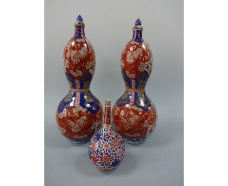 A PAIR OF ORIENTAL DOUBLE GOURD VASES AND COVERS, in red and blue enamels having cranes and flowers to bodies, gilt highlight