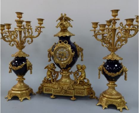 A FRENCH COBALT BLUE AND GILT CLOCK GARNITURE, the cobalt urn clock with segmented Roman numeral dial inscribed N. Cheneau Di